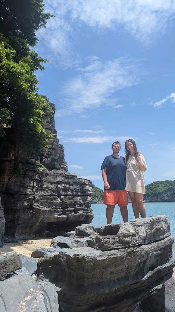 Limestone cliffs and fishing boats in Cat Ba bay at sunset